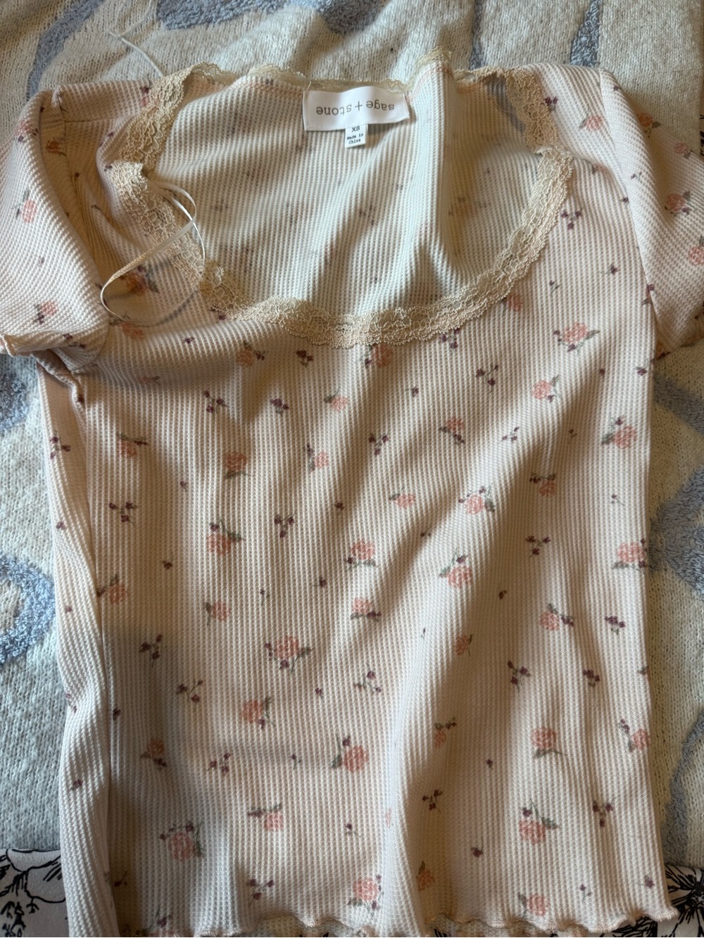 Light pink baby tee shirt with floral and lace designs